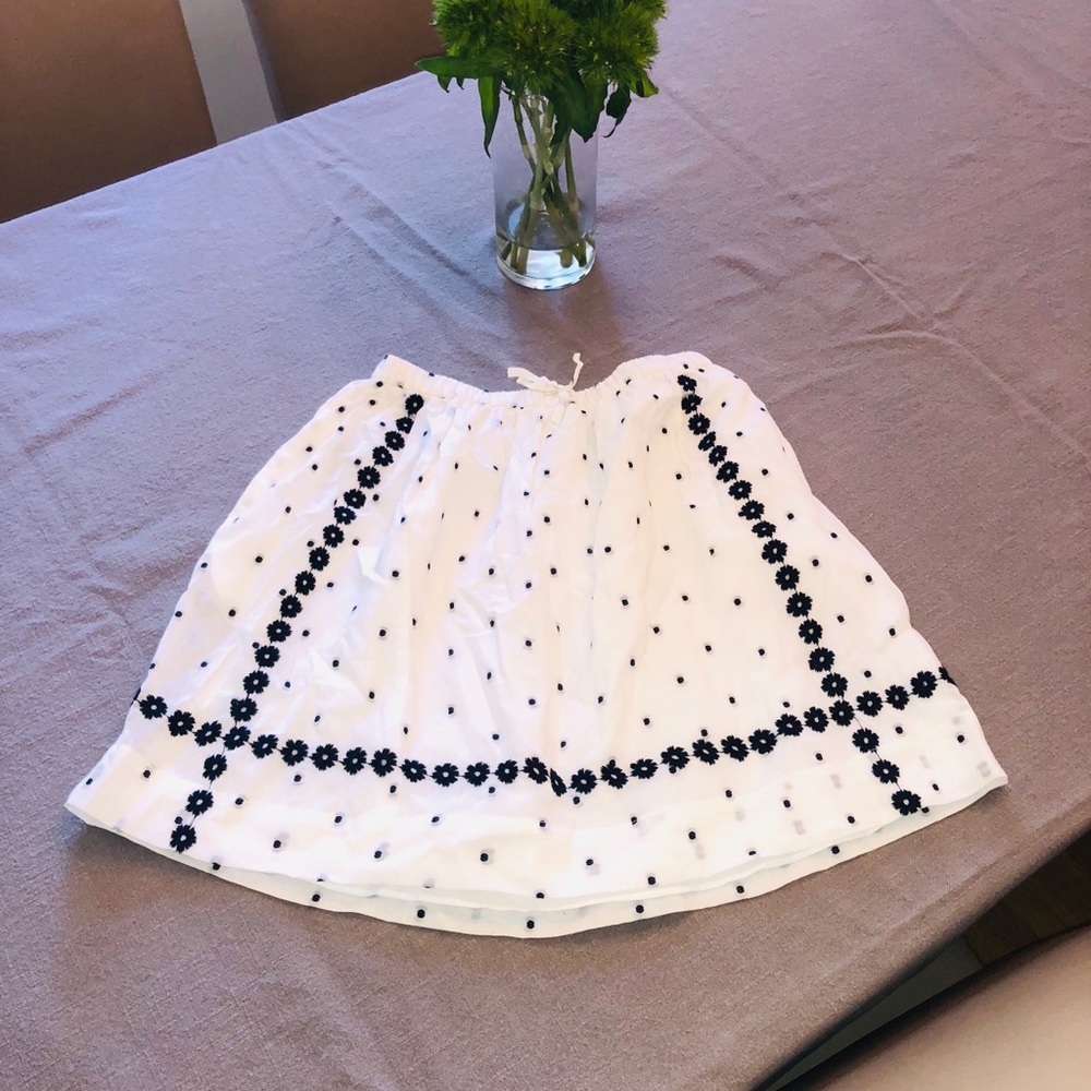 White a-line girls skirt with blue polkadots